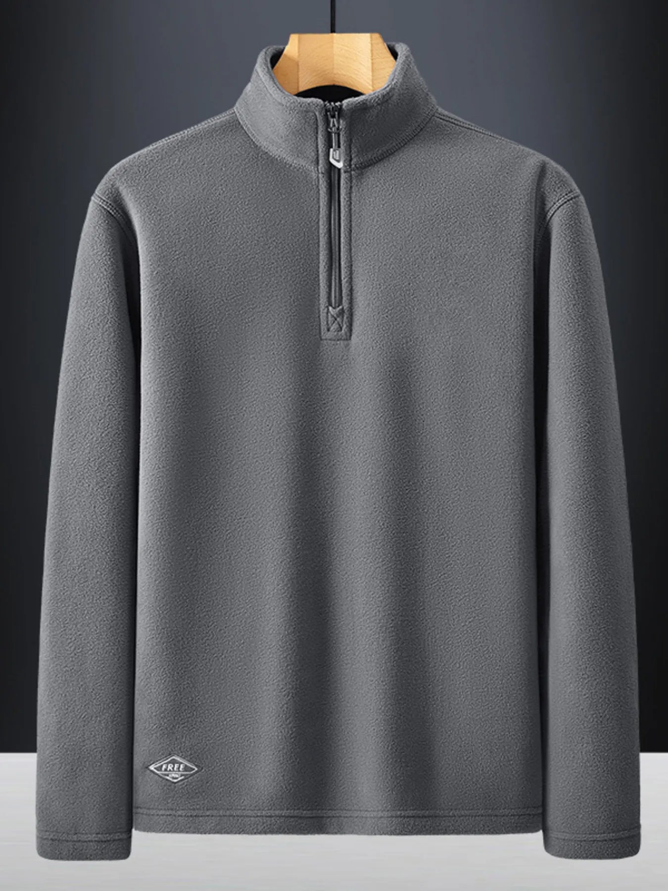 Plus-size dark gray quarter zip sweatshirt with fleece texture and embroidered logo detail.