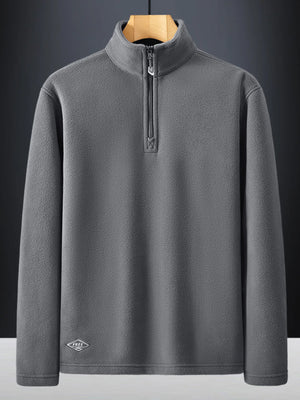 Plus-size dark gray quarter zip sweatshirt with fleece texture and embroidered logo detail.