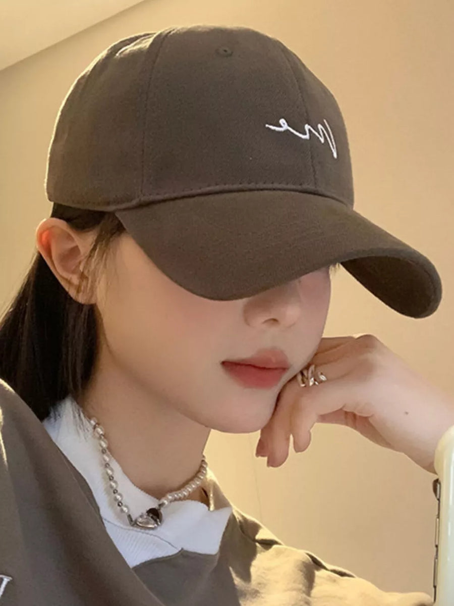 Grey cotton baseball cap with white embroidered detail and curved brim