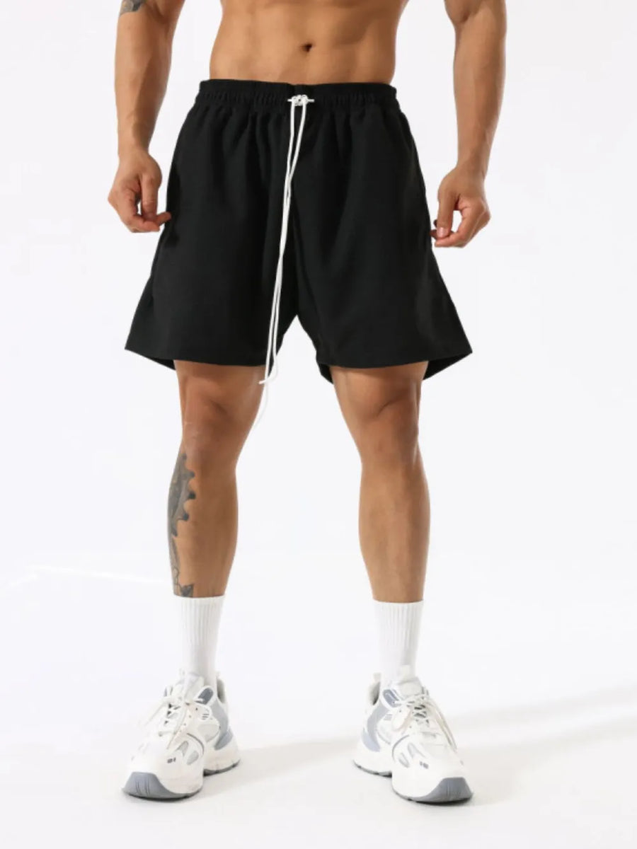 Black athletic drawstring lounge shorts with white tie detail.