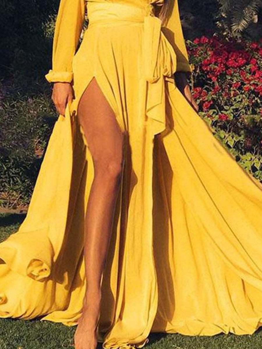 Plus size yellow surplice maxi dress with high slit and defined waist tie.