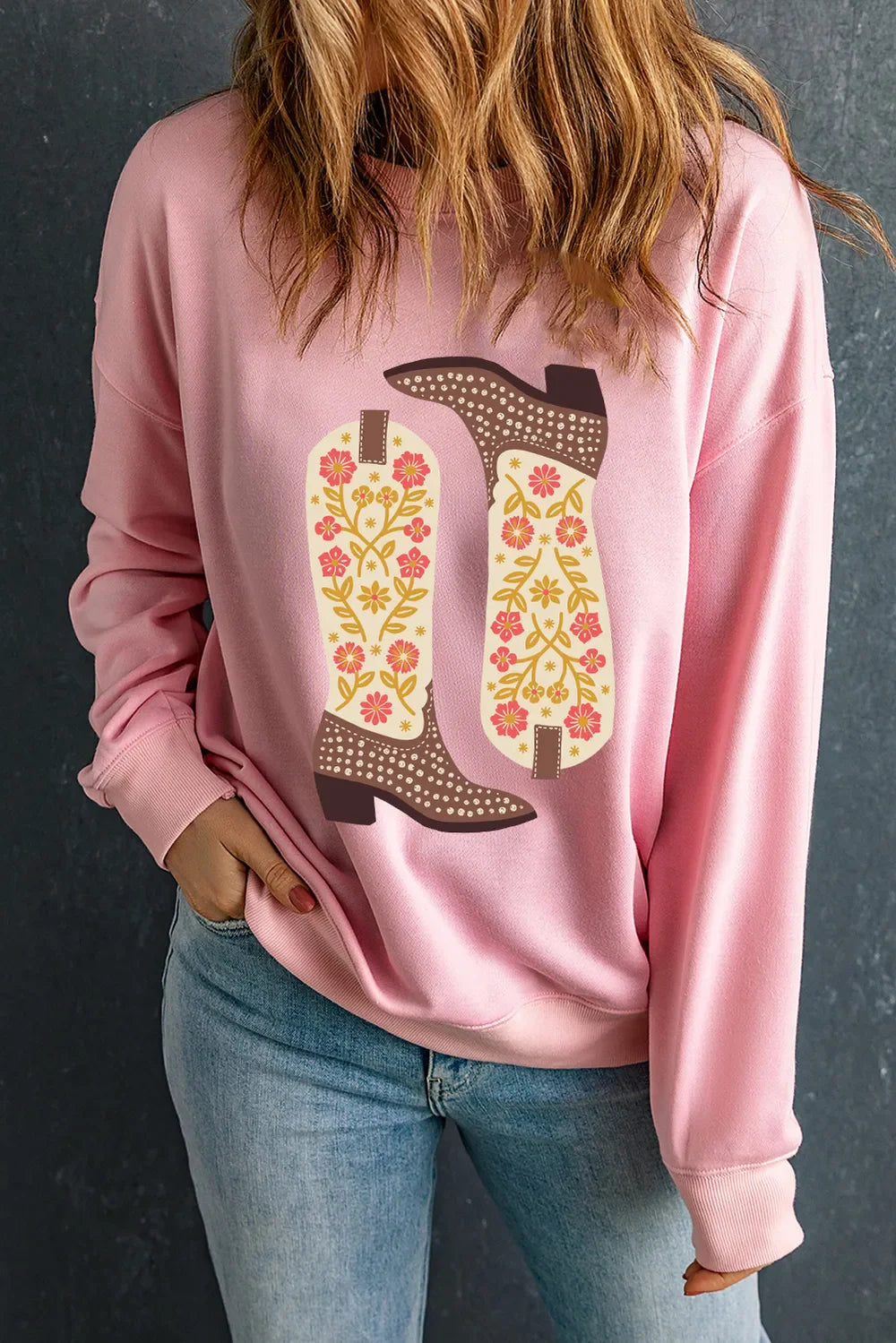 Blush pink crewneck sweatshirt with a floral boot graphic.