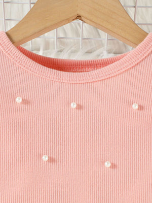 Pink ribbed baby top with pearl embellishments