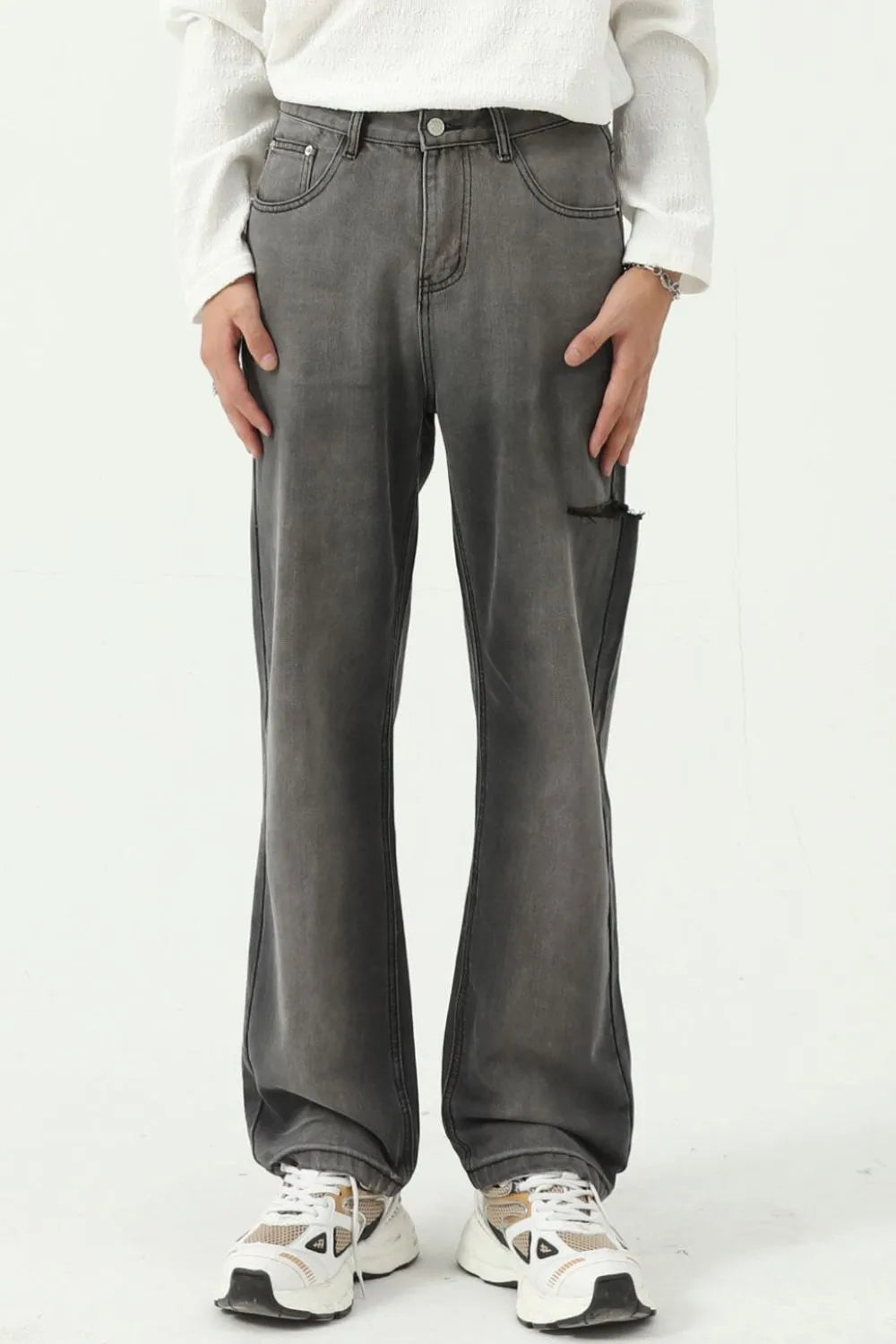 Faded flare denim jeans in dark wash with distressed knee detail and a relaxed fit.