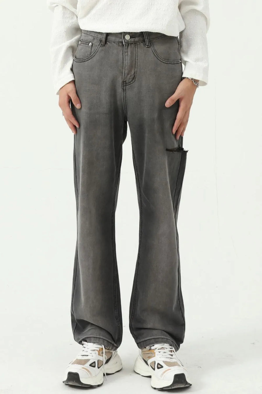 Faded flare denim jeans in dark wash with distressed knee detail and a relaxed fit.