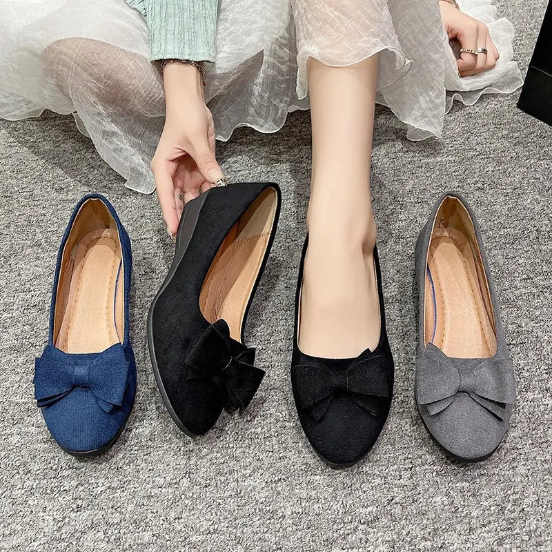 Bow-embellished suede ballet flats in black, navy, and dark gray.