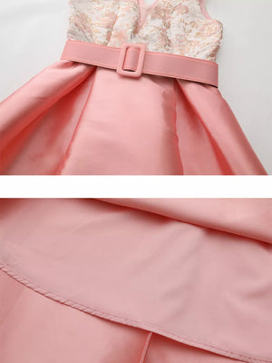 Pink midi dress with floral appliqué bodice, belted waist, and A-line skirt.