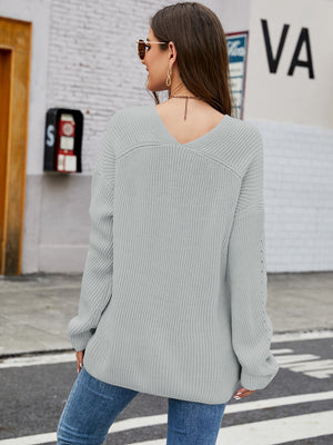 Slouchy ribbed knit sweater in heather gray with subtle sleeve detail and V-neck.