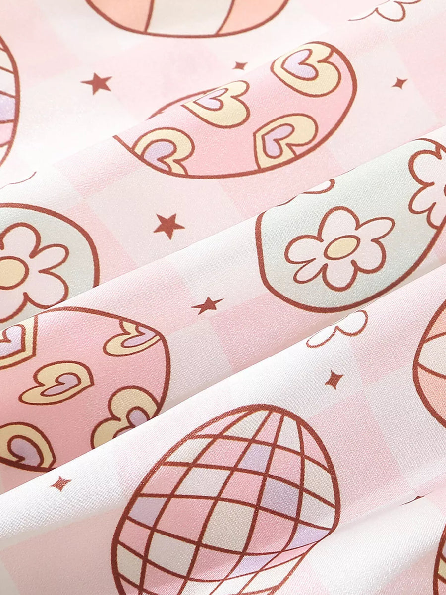 Pink cotton blend toddler pajamas with egg print, flowers, hearts, and stars.