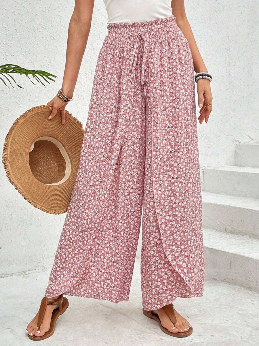 Floral print wrap-front palazzo pants in blush pink with a drawstring waist and wide leg.