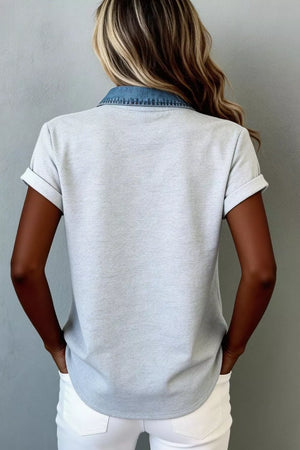 Light gray button-down overshirt with denim collar and cuffed short sleeves.