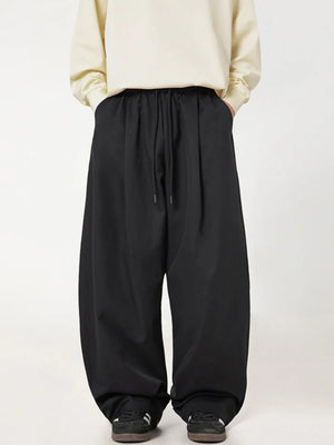 Black balloon-fit drawstring trousers with a casual, relaxed cut.