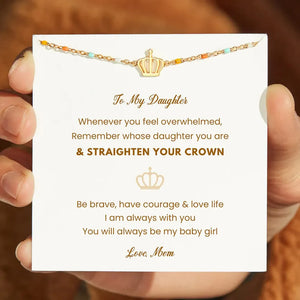 Gold crown charm bead bracelet with colorful enamel beads on a delicate chain.