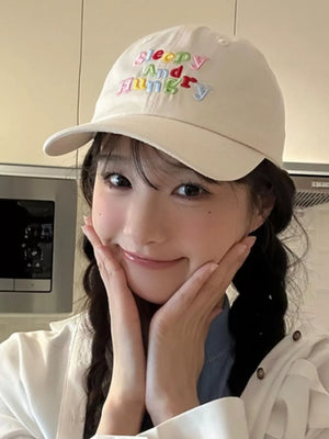 Beige baseball cap with colorful "Sleepy And Hungry" embroidery