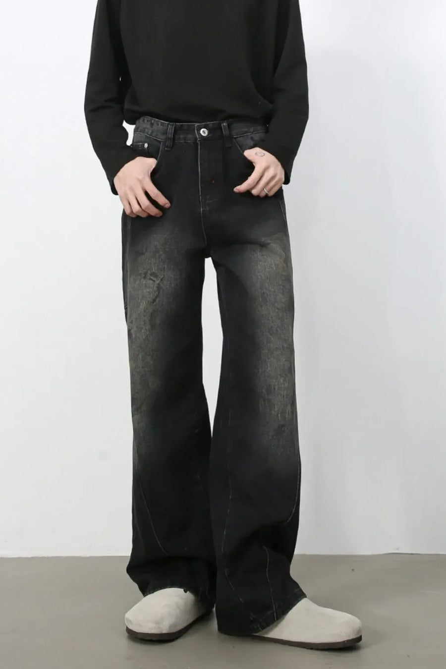 Faded wash wide leg denim jeans in dark with a distressed look.