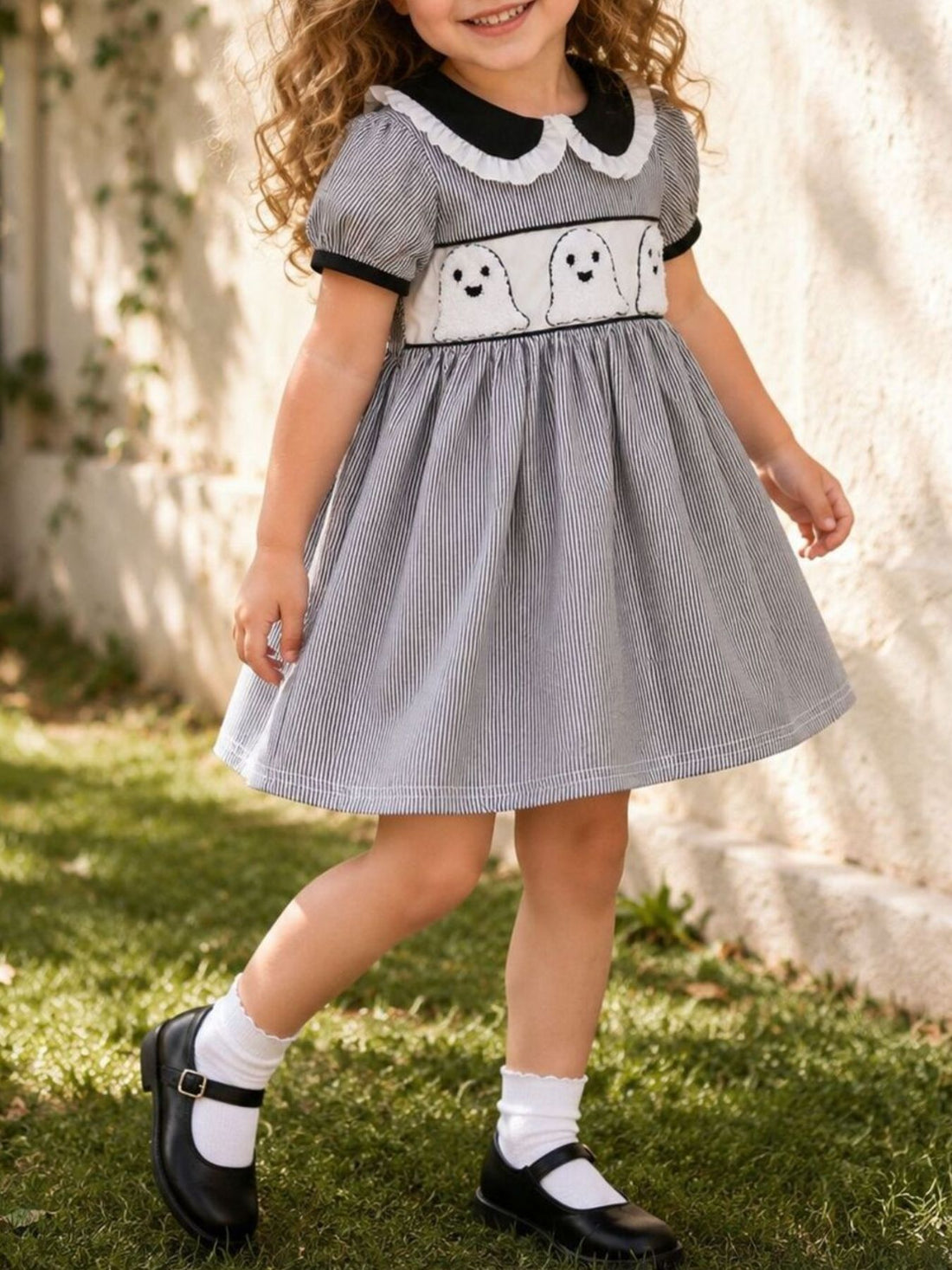 black A-line dress with striped and peter pan collar
