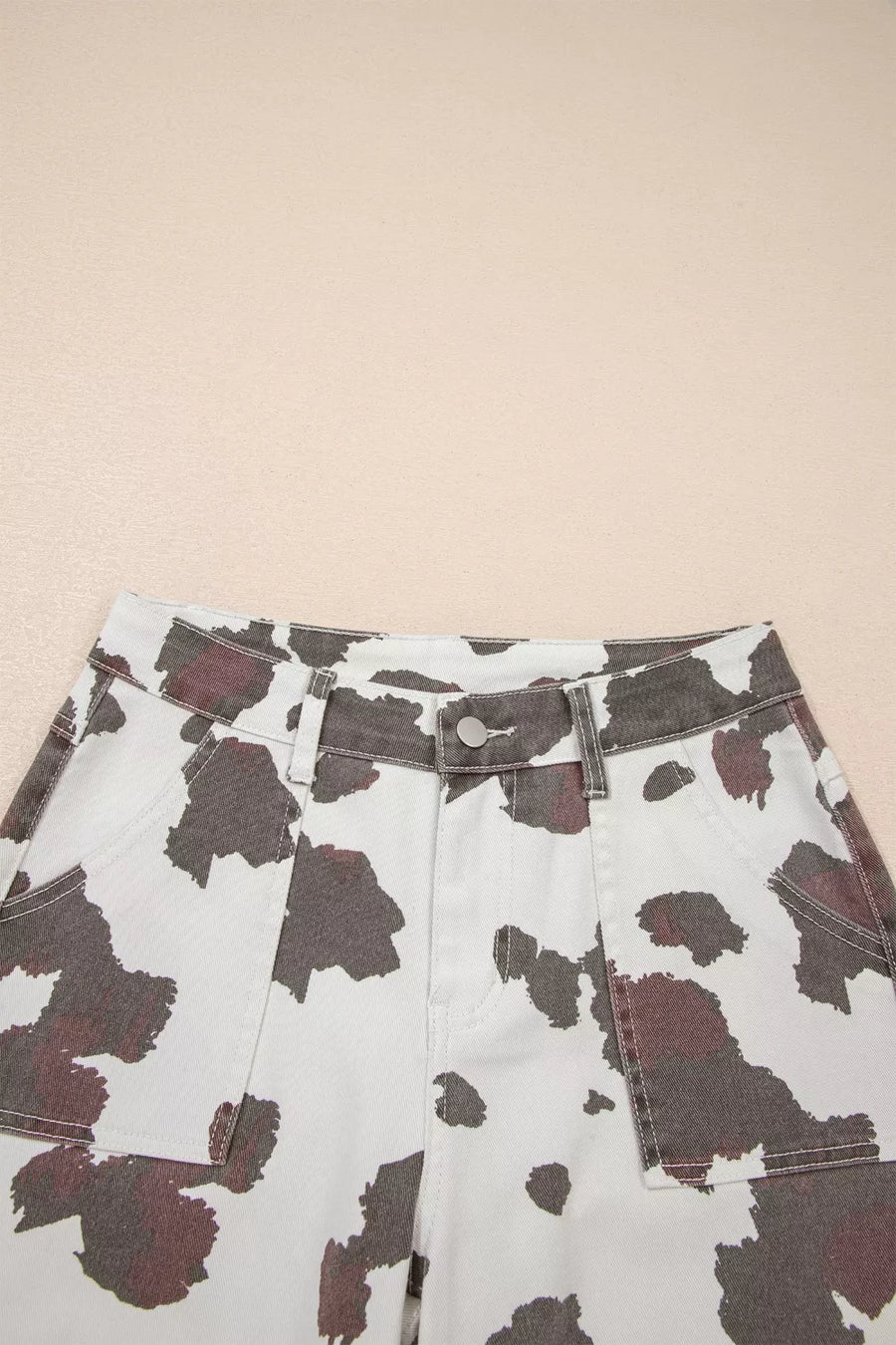 Cow print utility jeans in cotton blend with cargo pockets.