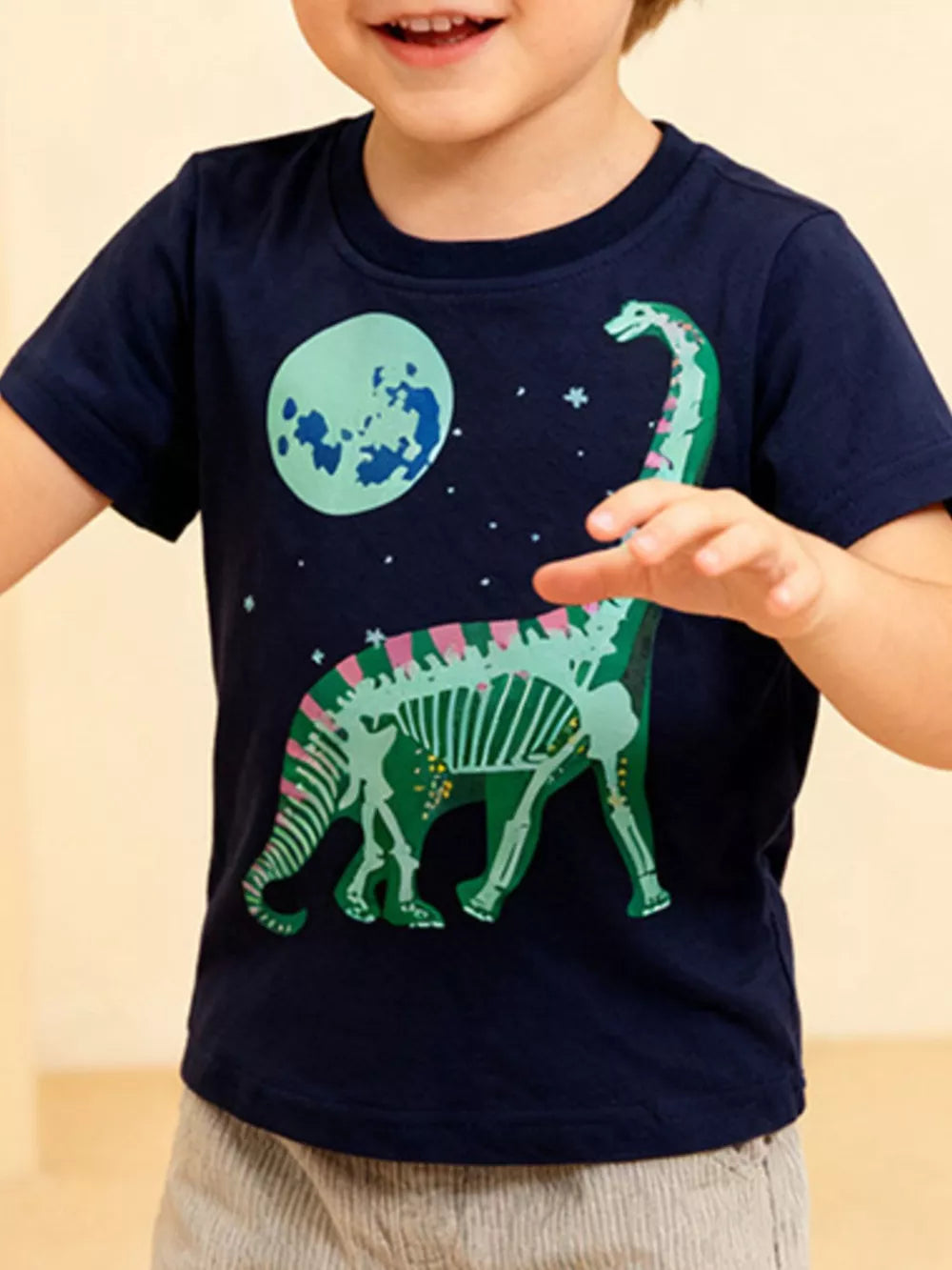 Navy cotton crew neck t-shirt with playful dinosaur skeleton graphic and moon.
