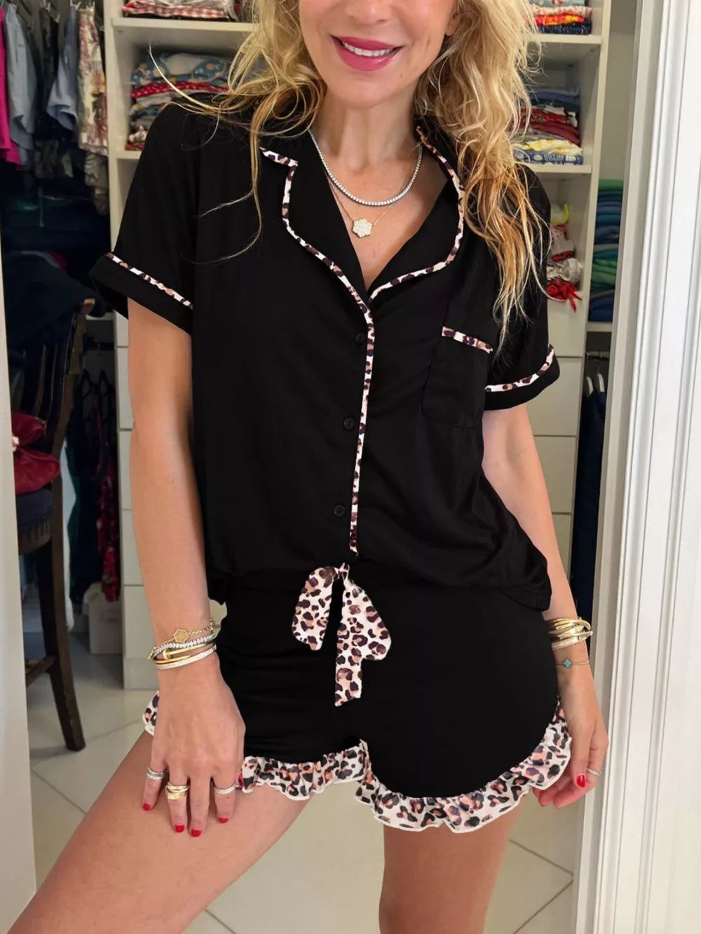 Chic black pajama set with leopard trim shorts and button-up top.