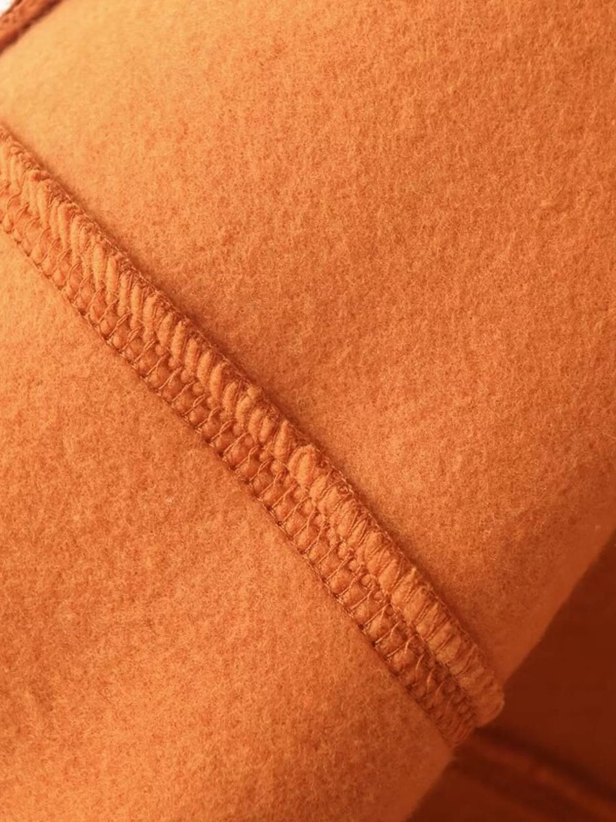 Orange casual zip-up top and wide-leg pants set detail showing textured stitching on soft fabric.