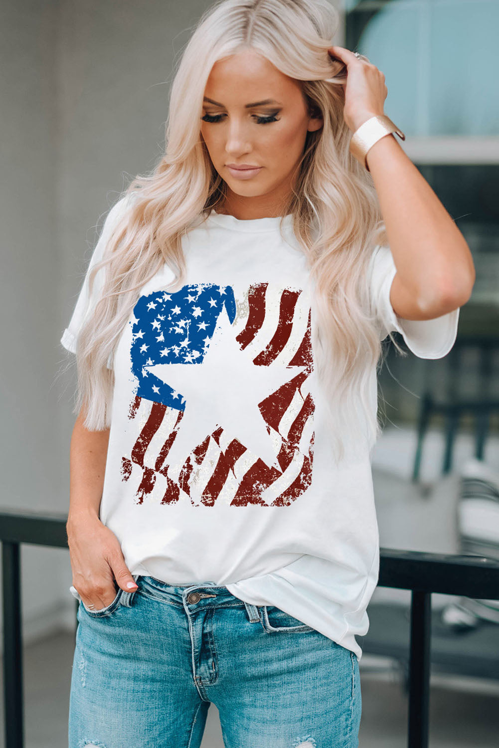 White round neck t-shirt with distressed American flag graphic.
