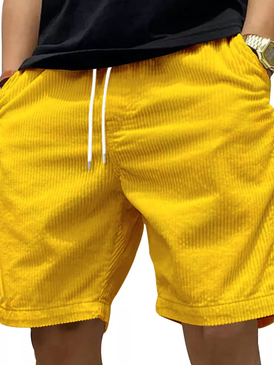 Yellow corduroy drawstring shorts with pockets and a white drawstring.
