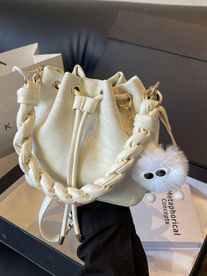 White bucket bag with chunky chain strap and fluffy charm