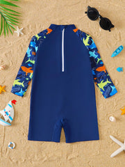 Navy baby rash guard swimsuit with shark print on sleeves and collar.