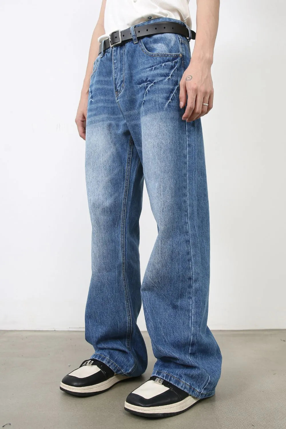 Baggy denim jeans in medium wash with distressed details and a relaxed fit.