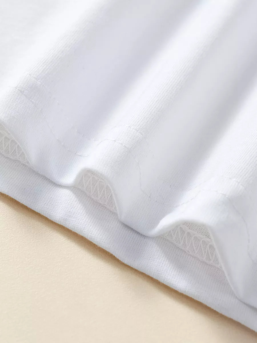 White cotton t-shirt hem detail with zig-zag stitching
