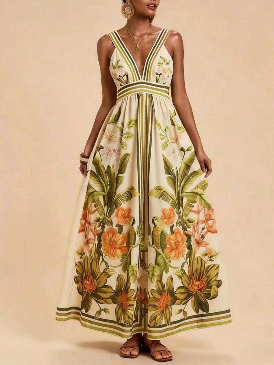 Tropical leaf print maxi dress with deep V-neck and striped straps.