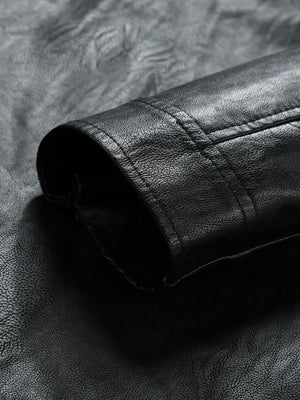 Black moto jacket detail showing textured faux leather and stitching.