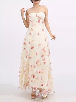 Strapless ivory tulle maxi dress with romantic floral appliques and a sweetheart neckline.
