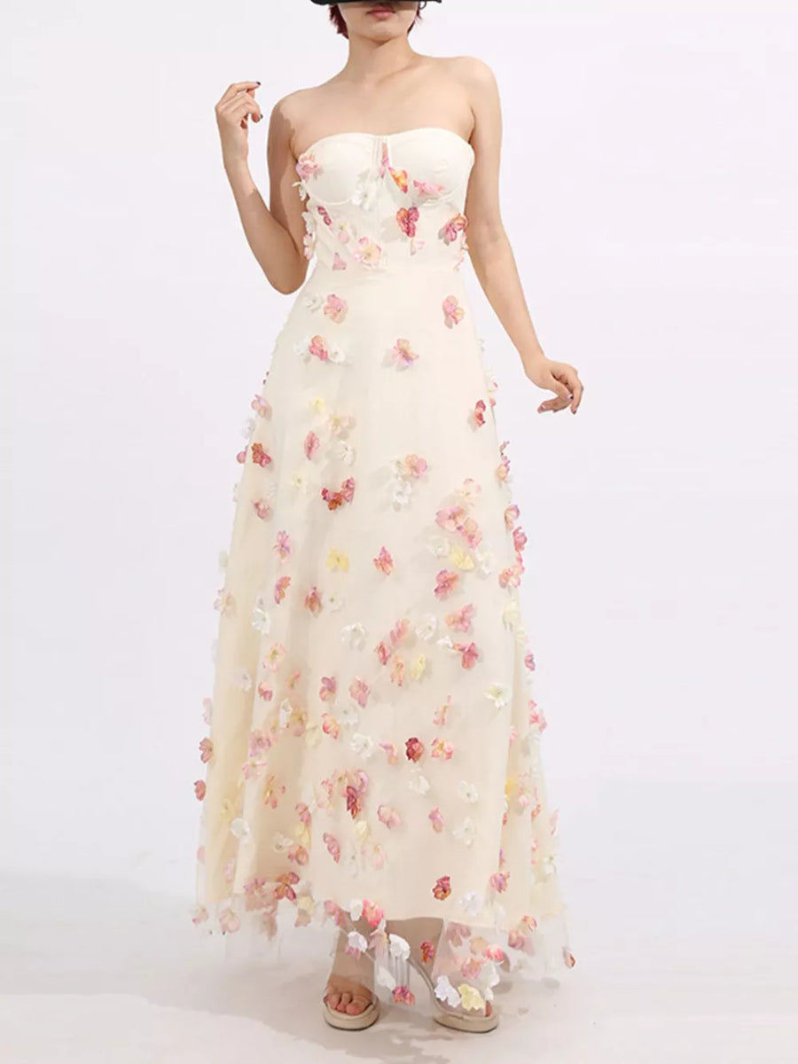 Strapless ivory tulle maxi dress with romantic floral appliques and a sweetheart neckline.