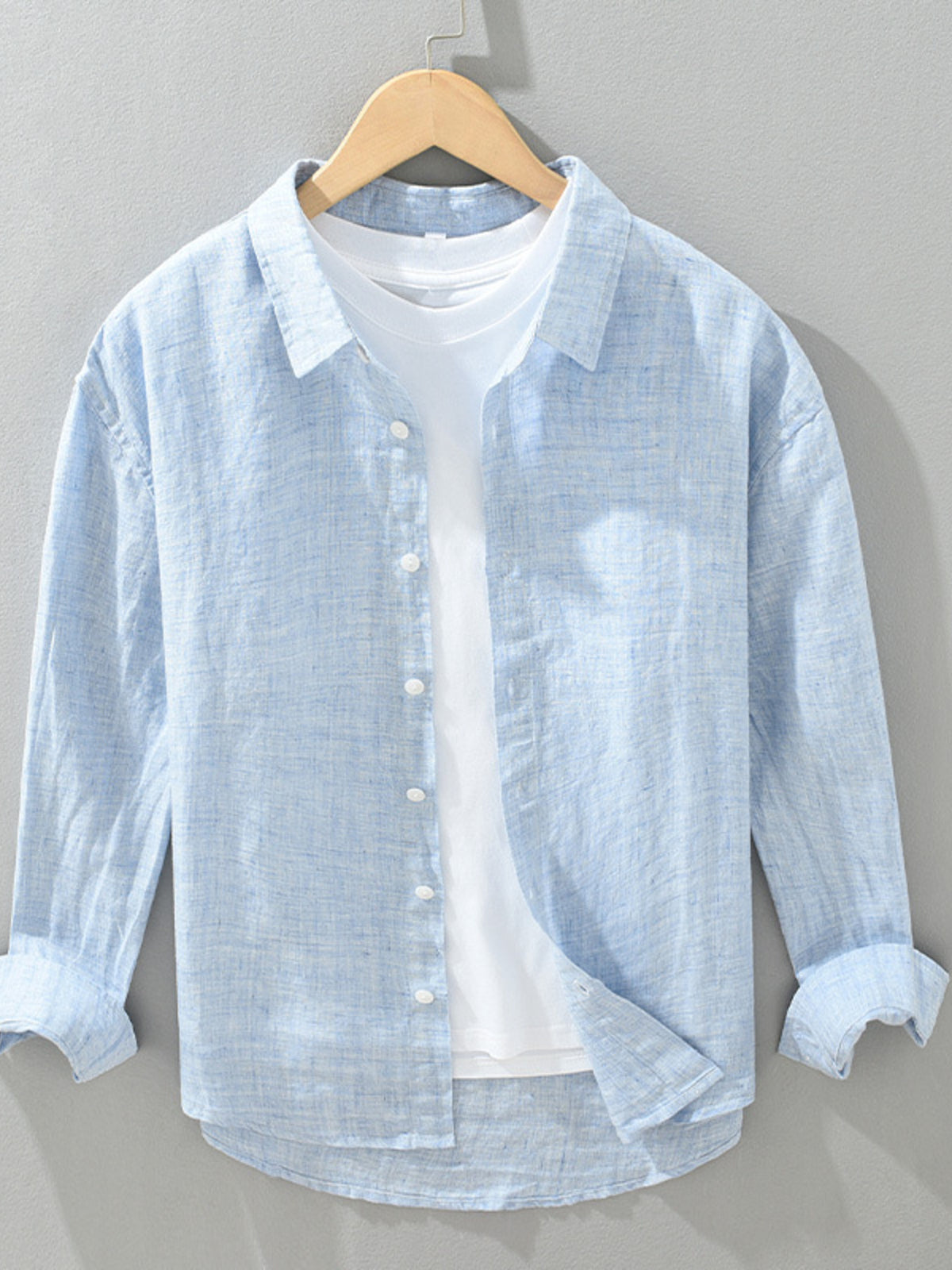 button-up shirt in light blue featuring button cuffs and regular fit