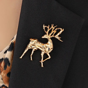 Gold geometric stag brooch lapel pin on a black blazer