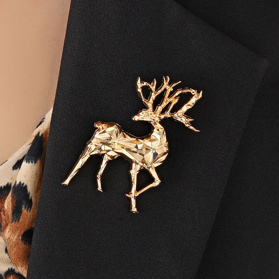 Gold geometric stag brooch lapel pin on a black blazer
