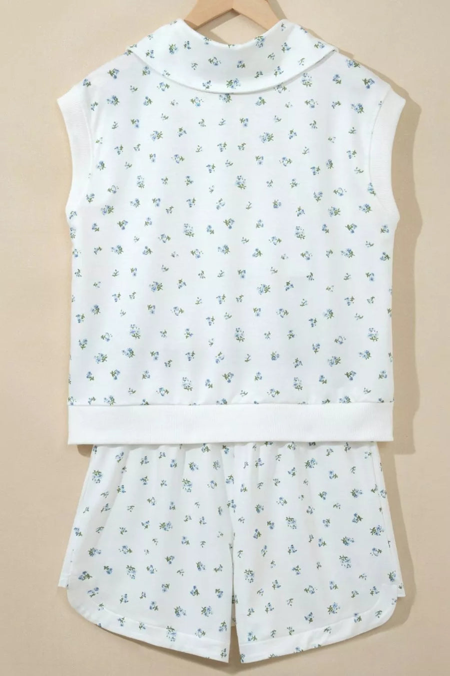 White floral print sleeveless top with collar and matching shorts