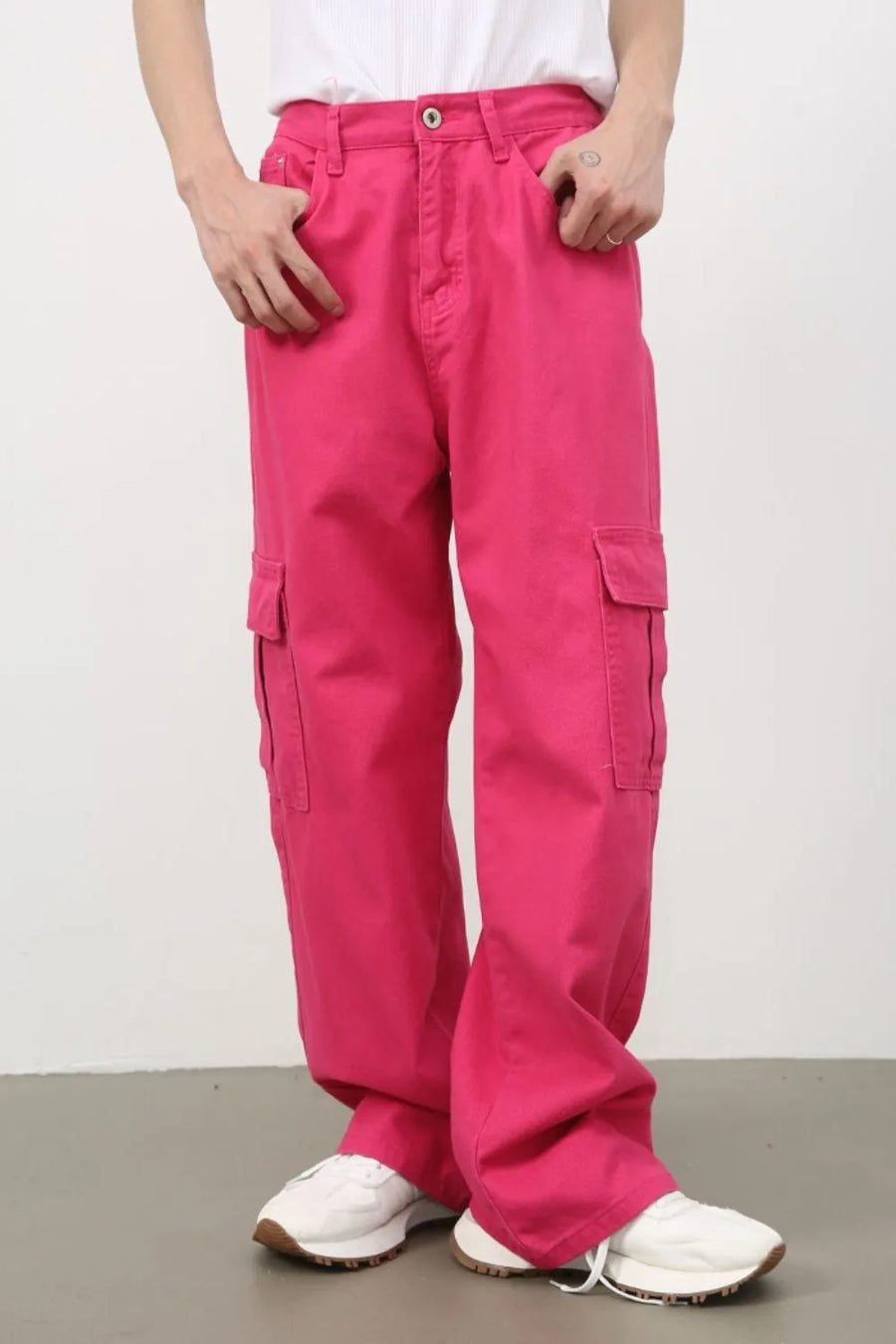 Electric pink baggy cargo pants with multiple pockets.