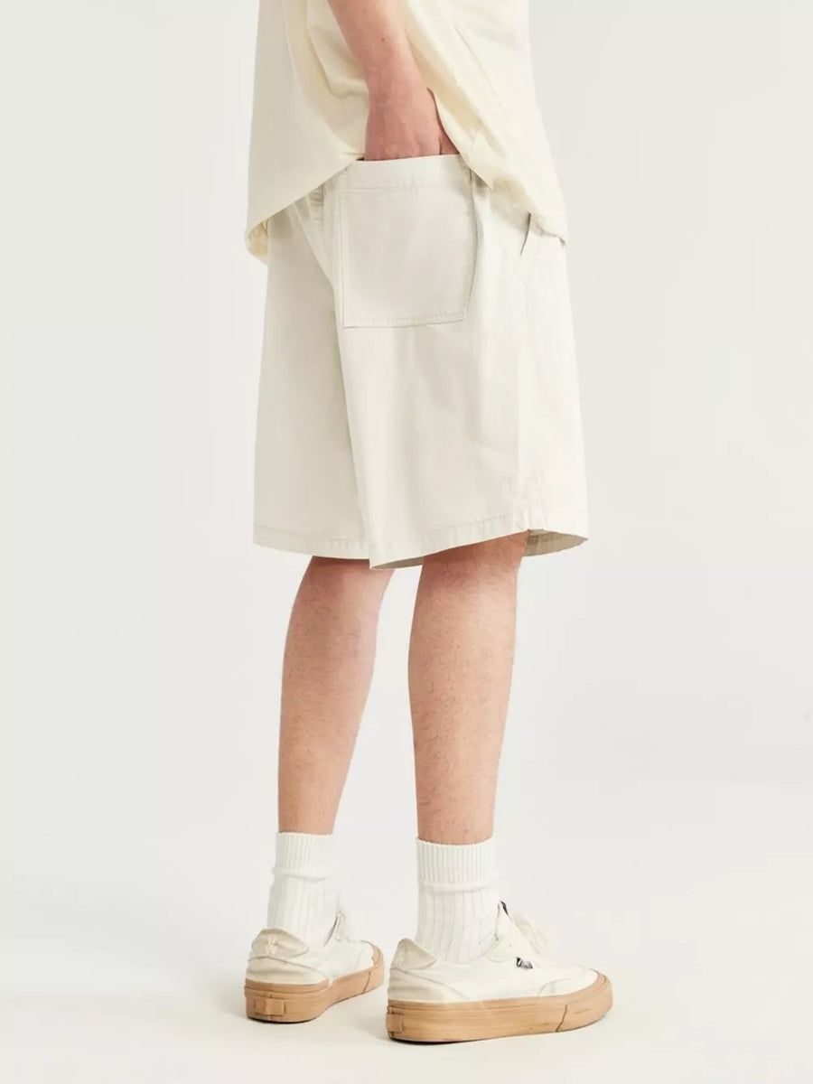 Men's ivory chino shorts with drawstring and back pocket detail.
