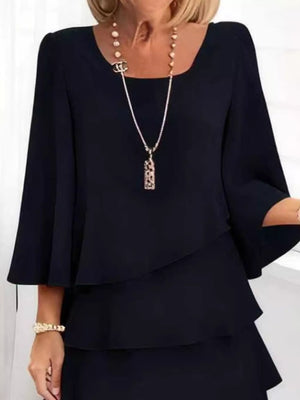 Black ruffled tiered dress with 3/4 bell sleeves and a square neckline.