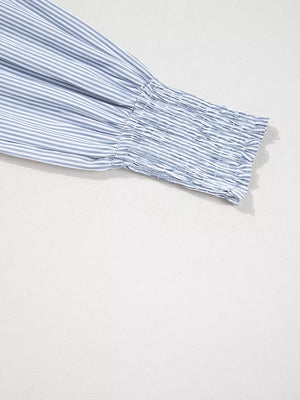 Striped blue and white cotton shirt sleeve with smocked cuff.