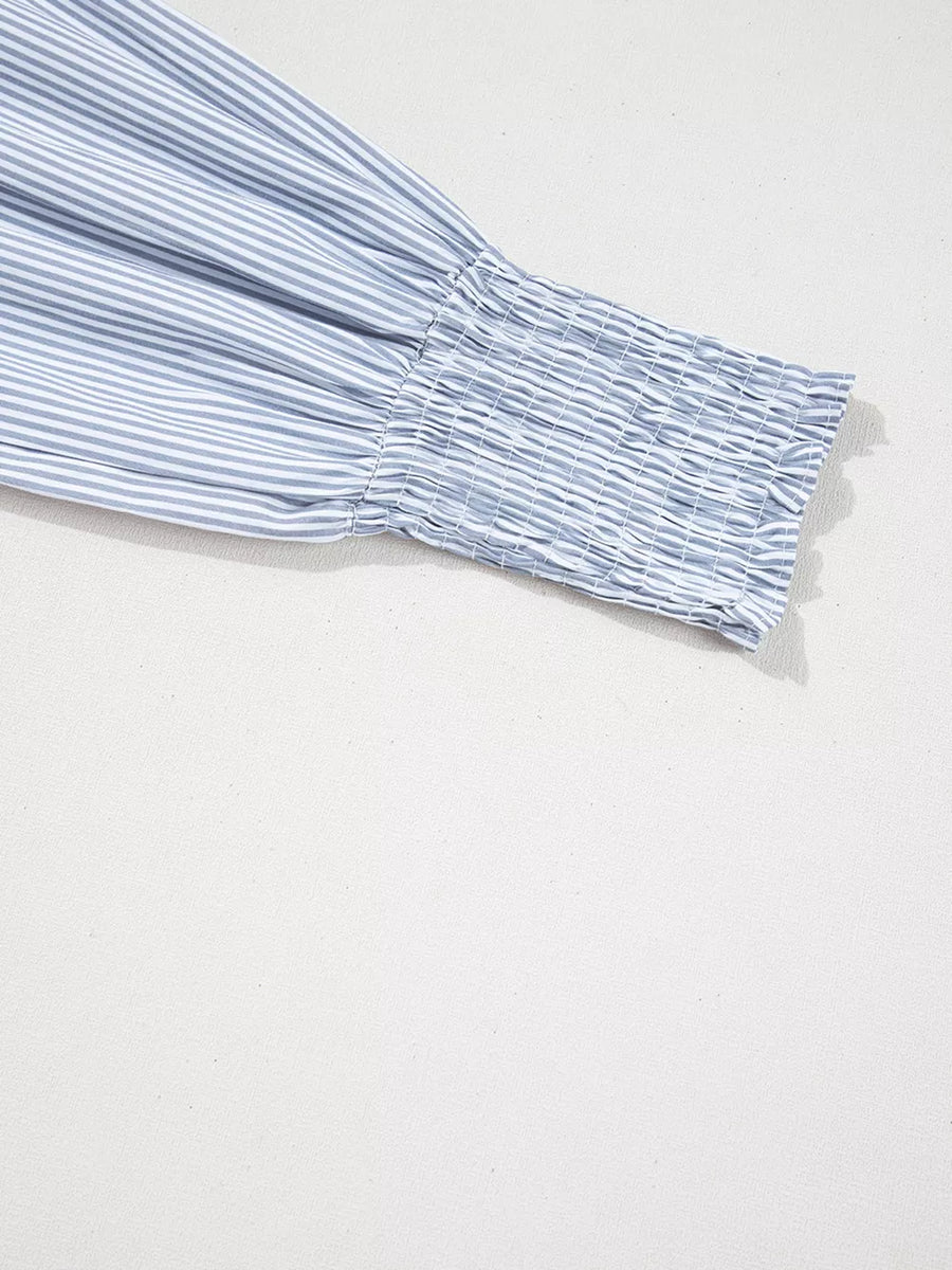 Striped blue and white cotton shirt sleeve with smocked cuff.