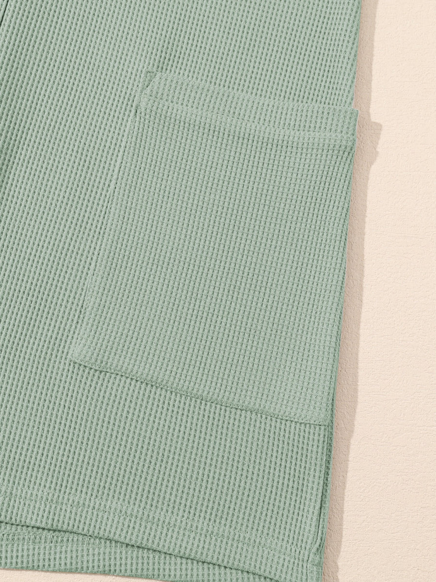 Sage waffle knit button-down romper with a chest pocket detail.