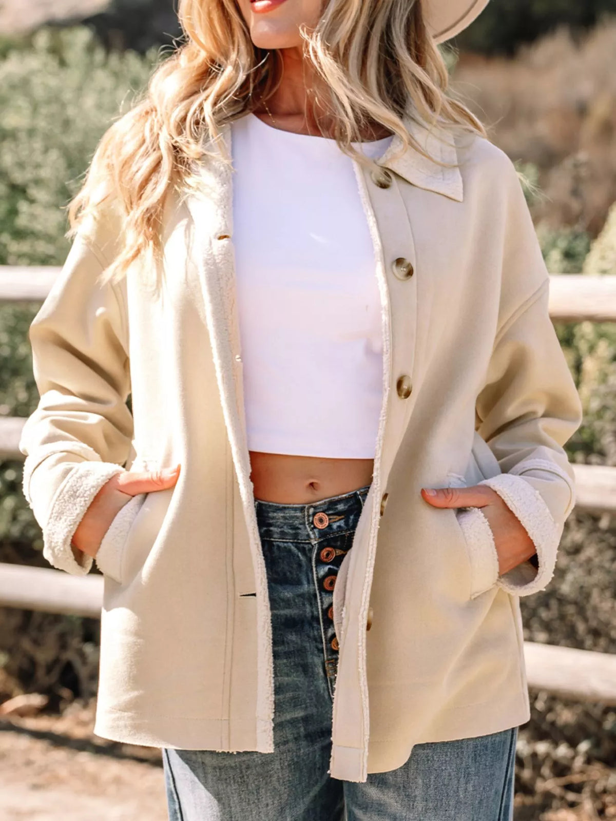 Lined Western jacket in eggshell with button front and sherpa trim cuffs.