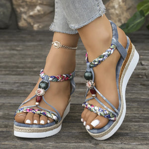 Bohemian beaded espadrille wedges in dusty blue with floral braided straps and a platform sole.