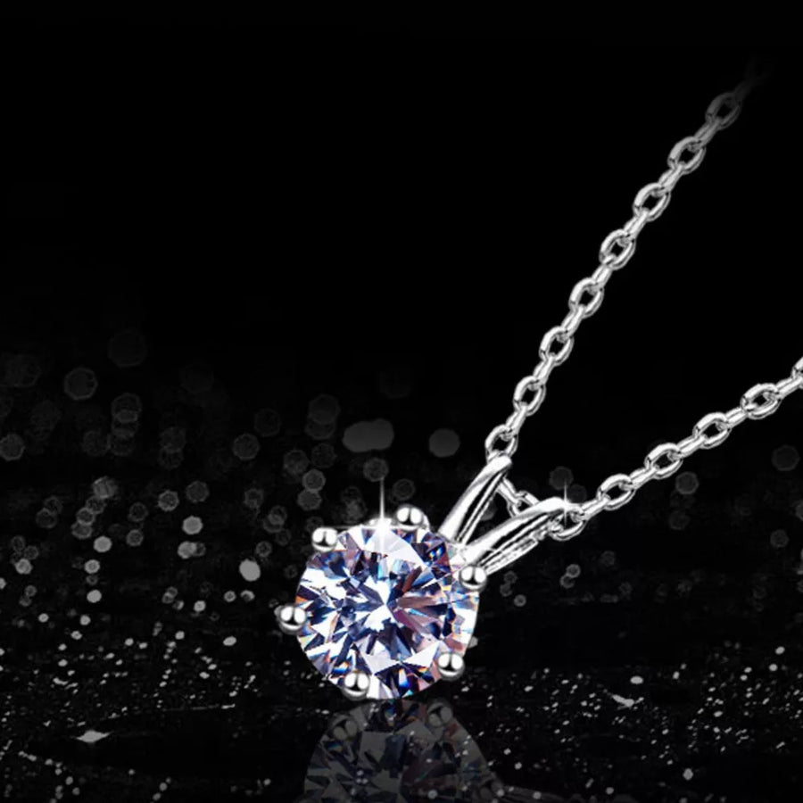 Elegant moissanite pendant necklace in sterling silver with a delicate chain.