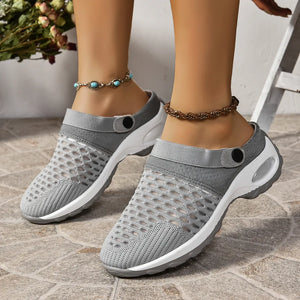 Gray breathable knit sport clogs with adjustable heel strap and white sole.