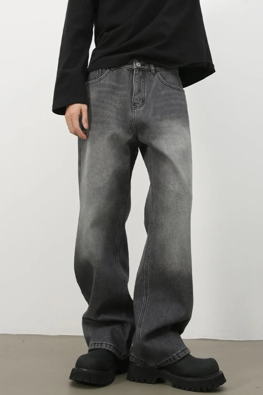 Faded dark gray denim jeans with a wide-leg silhouette and cotton material.