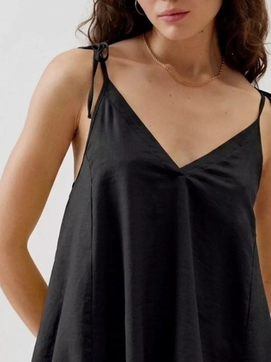 Black camisole with adjustable tie straps and V-neckline.